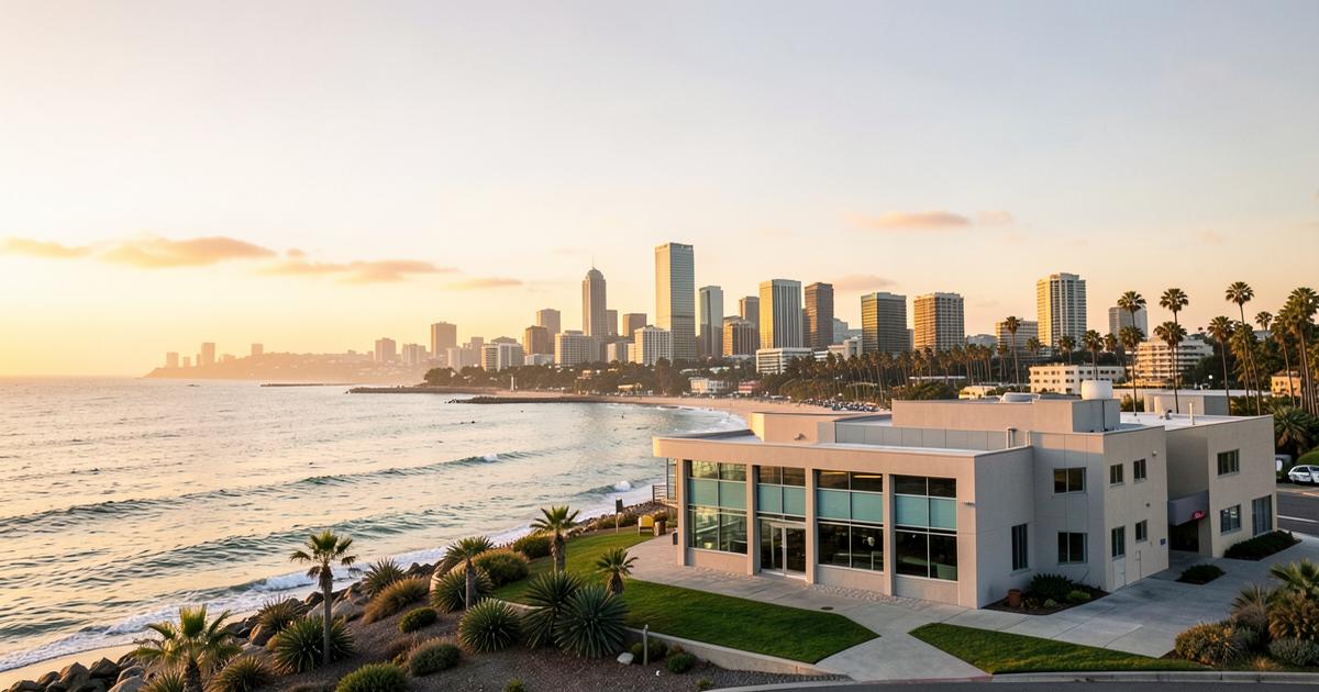 San Diego coastline and skyline at sunset with a modern medical clinic building